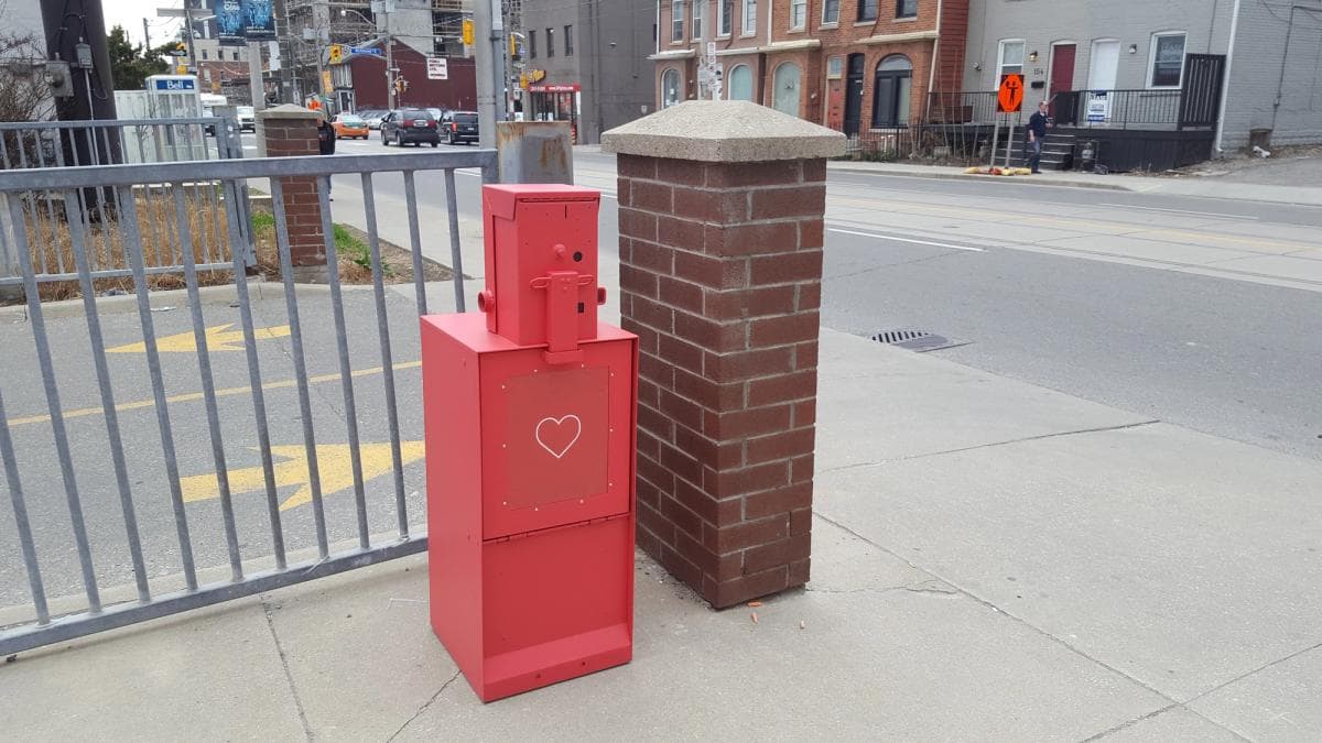 The Monthly — A hacked red newspaper box on Parliament Street, Toronto.
